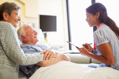 Elderly couple talking to nurse